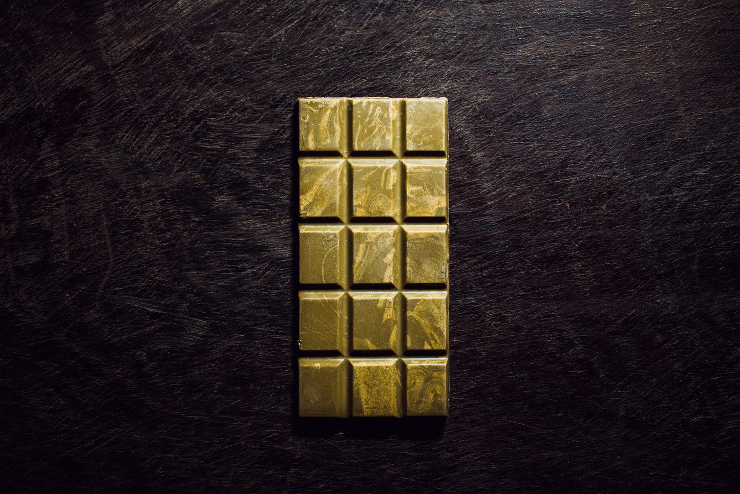 Handcrafted white chocolate bar with 36% cacao and matcha on traditional Guatemalan textile background